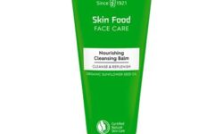 A tall conical metallic green tube with a bright white plastic lid that has Weleda Skin Food Nourishing Cleansing Balm written in bright white writing on it, on a white background.