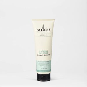 A tall conical creamy white plastic tube with a black plastic lid that has Sukin Balancing Scalp Scrub written in bold black writing on it, on a white background.