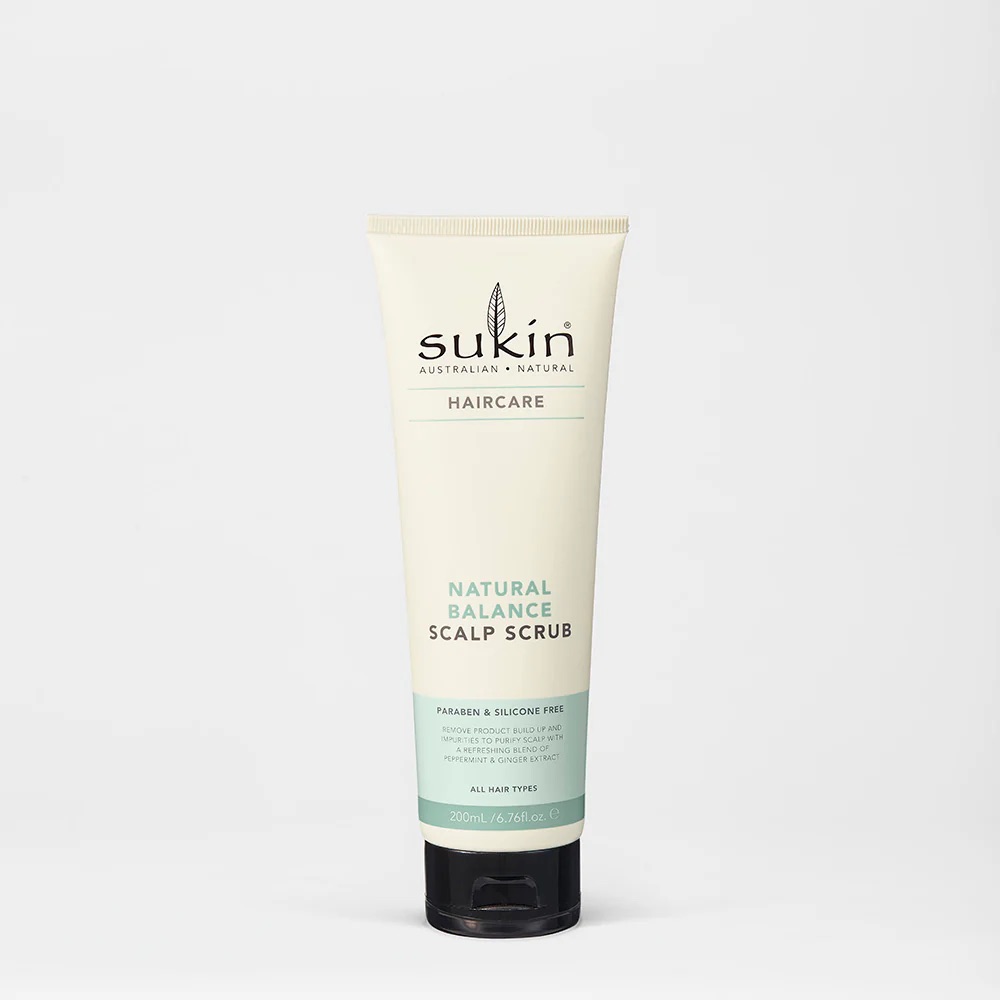 I Love Having A Soft & Balanced Scalp | Sukin Balancing Scalp Scrub A tall conical creamy white plastic tube with a black plastic lid that has Sukin Balancing Scalp Scrub written in bold black writing on it, on a white background.