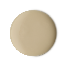 A medium circular puddle of some glossy ivory white shower gel, on a white background.