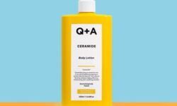 A tall cylindrical bright yellow plastic bottle with a white plastic pump lid and a bright yellow label that has Q+A Ceramide Body Lotion written in bold black writing on it, on a white background.