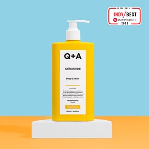 Answering The Age-Old Question Of Why Don't I Have A Soft Body? | Q+A Ceramide Body Lotion A tall cylindrical bright yellow plastic bottle with a white plastic pump lid and a bright yellow label that has Q+A Ceramide Body Lotion written in bold black writing on it, on a white background.
