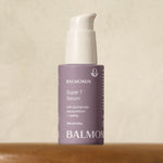 Taking Part In The Super Series Of Hydration | Balmonds Super 7 Serum A short cylindrical pastel purple glass Bottle with a metallic white pump lid that has Balmonds Super 7 Serum written in bright white writing on it, on a white background.