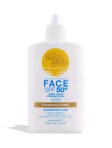 A short rectangular white plastic bottle with a white plastic lid that has Bondi Sands SPF50+ Fragrance Free Face Sunscreen Fluid written in dark blue writing, a picture of a bright yellow circle, and a picture of a bright gold stripe on it, on a white background.