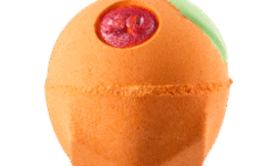 A medium bright orange rounded hexagonal shaped bath bomb that has a dark green leaf and the number 30 written in bright red lustre engraved on it, on a white background.