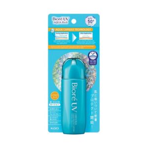 A short cylindrical bright turquoise plastic bottle with a bright turquoise plastic lid that has Bioré UV Aqua Rich Aqua Protect Lotion SPF50+ PA++++ written in bright white writing on it attached to a large rectangular piece of bright blue cardboard that has a picture of a bright orange and white stripe on it, on a white background.