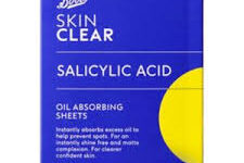 A small rectangular dark blue cardboard box that has Boots Skin Clear Oil Absorbing Sheets written in bright white writing on it, on a white background.