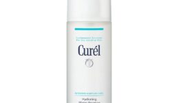 A tall flattened cylindrical frosted white plastic Bottle with a frosted white plastic Lid that has Curél Hydrating Water Essence written in bold dark blue writing on it, on a white background.