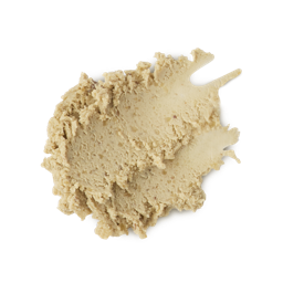 A medium circular puddle of some creamy ivory cleanser that has some pieces of Ground Almond running through it, on a white background.