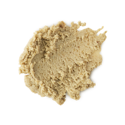 A medium circular puddle of some creamy sandy yellow cleanser that has some pieces of Ground Almond running through it, on a white background.