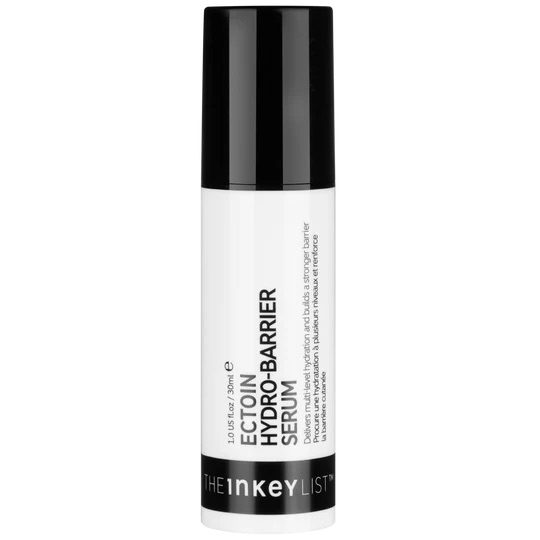 Tattooing The Hydrating Power Of Ectoin Into My Skin | The INKEY List Ectoin Hydro-Barrier Serum A tall cylindrical bright white plastic Bottle with a black plastic lid that has The INKEY List ectoin Hydro Barrier Serum written in bold black writing and a picture of a black stripe on it, on a white background.