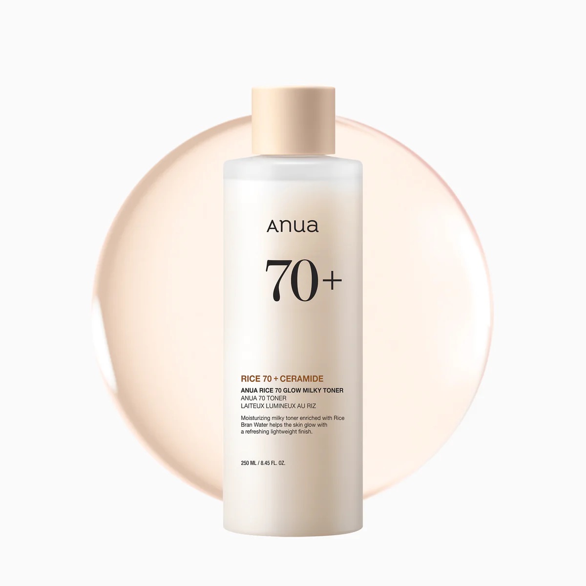 A tall cylindrical frosted white plastic bottle full of some translucent creamy white liquid with a beige plastic lid and a bright white label that has Anua Rice 70 Milky Toner written in bold black writing on it, on a white background.
