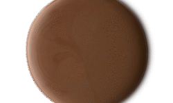 A medium circular puddle of some glossy dark caramel brown shower gel, on a white background.