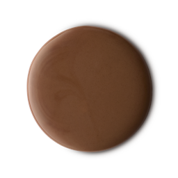 A medium circular puddle of some glossy dark caramel brown shower gel, on a white background.