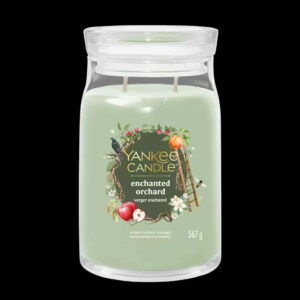 A tall cylindrical glass jar full of some pale green wax with a label that has Yankee Candle written in bright white writing, Enchanted Orchard written in bright white writing, and a picture of some dark green apples, a large orange, a ladder, a small black bird, some white blossom flowers, and some dark brown branches on it, on a black background.
