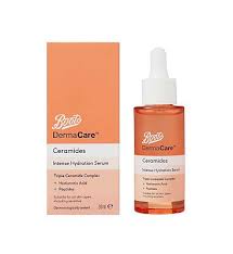 Giving My Skin A Good Kick Of Protection With Ceramides | Boots DermaCare Ceramides Range A short cylindrical clear glass bottle full of some translucent bright orange liquid with a bright white rubber pipette lid and a gradient bright orange and white label that has Boots DermaCare Ceramides Intense Hydration Serum written in bold black writing on it next to a short cylindrical gradient bright orange and white cardboard box that has Boots DermaCare Ceramides Intense Hydration Serum written in bold black writing on it, on a white background.