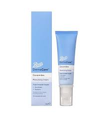 A tall gradient bright blue and white plastic tube with a clear plastic lid and a gradient bright blue and white label that has Boots DermaCare Ceramides Moisturising Cream written in bold black writing on it next to a tall rectangular gradient bright blue and white cardboard box that has Boots DermaCare Ceramides Moisturising Cream written in bold black writing on it, on a white background.