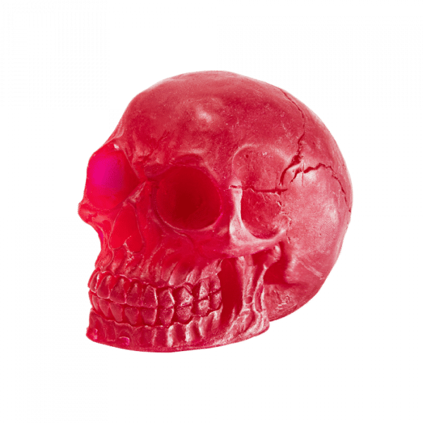 A large dark red skull shaped block of soap that has some Eye Sockets, some Teeth, and some Cranial Cracks engraved on it, on a white background.
