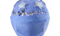 A medium bright lilac purple rounded hexagonal shaped bath bomb that has two large shimmering silver stars, some pieces of iridescent Popping Candy, and some dark purple spots all over it, on a white background.