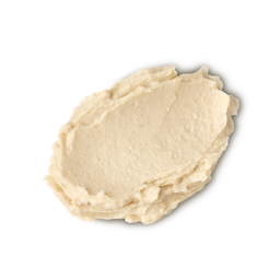 A medium circular puddle of some light beige Shampoo, on a white background.