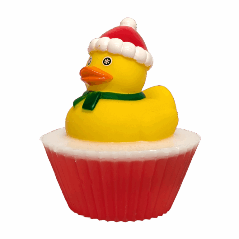 A large circular bright white cupcake shaped block of soap that has a bright red paper cupcake case around it and a bright Yellow Rubber Duck with a bright orange beak, a bright red Santa’s Hat, and a dark green scarf sat on top of it, on a white background.