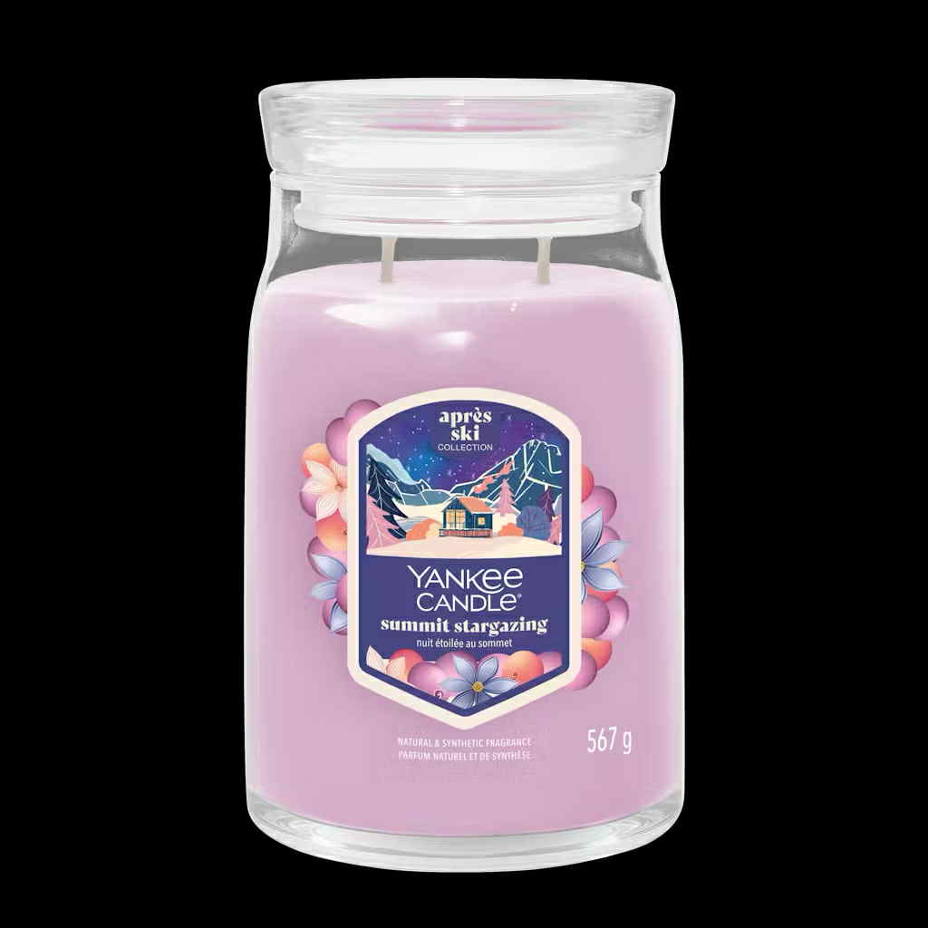What I Thought of the Yankee Candle Advent House 2014 A tall cylindrical glass Jar full of some Pastel Purple Wax with a Label that has Yankee Candle written in bright white writing, Summit Stargazing written in bright white writing, and a picture of a large dark brown mountain cabin surrounded by a dark blue sky and some bright white stars on it, on a white background.