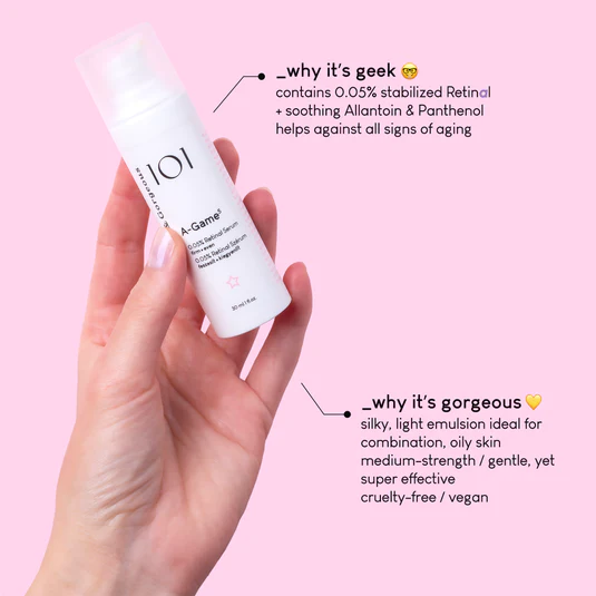 You Really Need To Step Up Your Game If You Want To Achieve Younger Looking Skin | Geek & Gorgeous 101 A-Game 5 0.05% Retinal Serum A hand holding a short cylindrical bright white plastic bottle with a bright white plastic lid that has Geek & Gorgeous 101 A-Game 5 0.05% retinal Serum written in bold black writing on it, on a bright pink background.