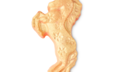 A medium bright gold rearing horse shaped bath bomb that’s stood up on it’s hind legs and has a star pattern and some bright gold lustre all over it, on a white background.