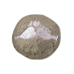A medium textured brownish grey block of solid cleanser that has a picture of two birds kissing underneath a heart engraved on it and some shiny silver lustre all over it, on a white background.