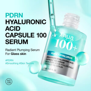 A short cylindrical clear glass bottle full of some translucent turquoise liquid with a clear rubber pipette lid and a bright silver label that has Anua PDRN Hyaluronic Acid Capsule 100 Serum written in bright white writing and a picture of a light blue stripe on it, on a gradient mint green background..