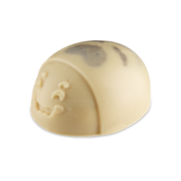 I Am Your Mother, You Listen To Me !| Lush Mother's Day 2026 Range A medium creamy white oval Ladybird shaped block of solid Body Scrub that has some dark brown stripes on it’s back and a large smiling face engraved on it, on a white background.