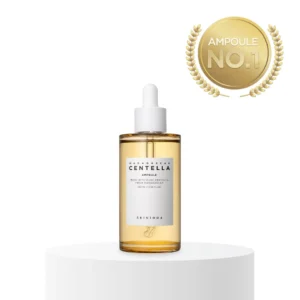 A tall cylindrical clear glass bottle full of some golden yellow liquid with a bright white Rubber Pipette lid and a bright white label that has Skin1004 Madagascar Centella Ampoule written in bold black writing on it, on a white background.