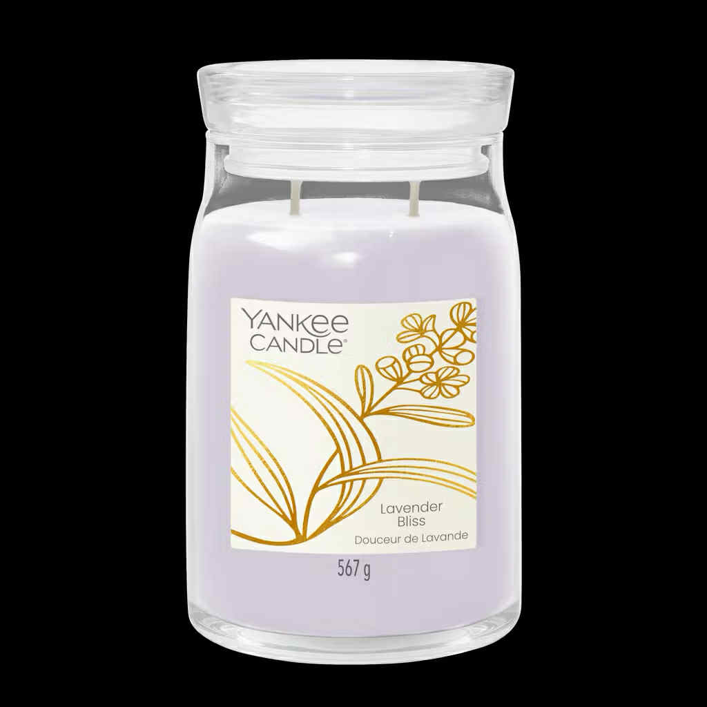 Enjoying Life's Little Luxuries | Yankee Candle Little Luxuries Collection A tall cylindrical glass Jar full of some pale lavender Wax with a bright white label that has Yankee Candle written in bold black writing, Lavender Bliss written in bold black writing, and a picture of some stylised bright gold lavender flowers and leaves on it, on a white background.