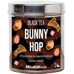 A tall cylindrical clear plastic Jar with a bright silver metal lid and a dark brown label that has Bunny Hop loose Leaf Tea written in bright white writing and some pictures of some stylised bars of chocolate and wrapped sweets on it, on a black background that has some black and dark brown shapes all over it.