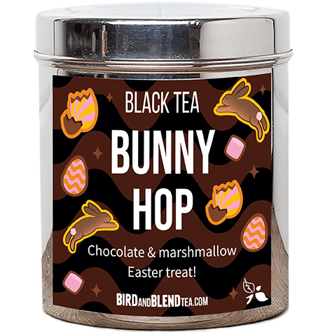 A tall cylindrical clear plastic Jar with a bright silver metal lid and a dark brown label that has Bunny Hop loose Leaf Tea written in bright white writing and some pictures of some stylised bars of chocolate and wrapped sweets on it, on a black background that has some black and dark brown shapes all over it.
