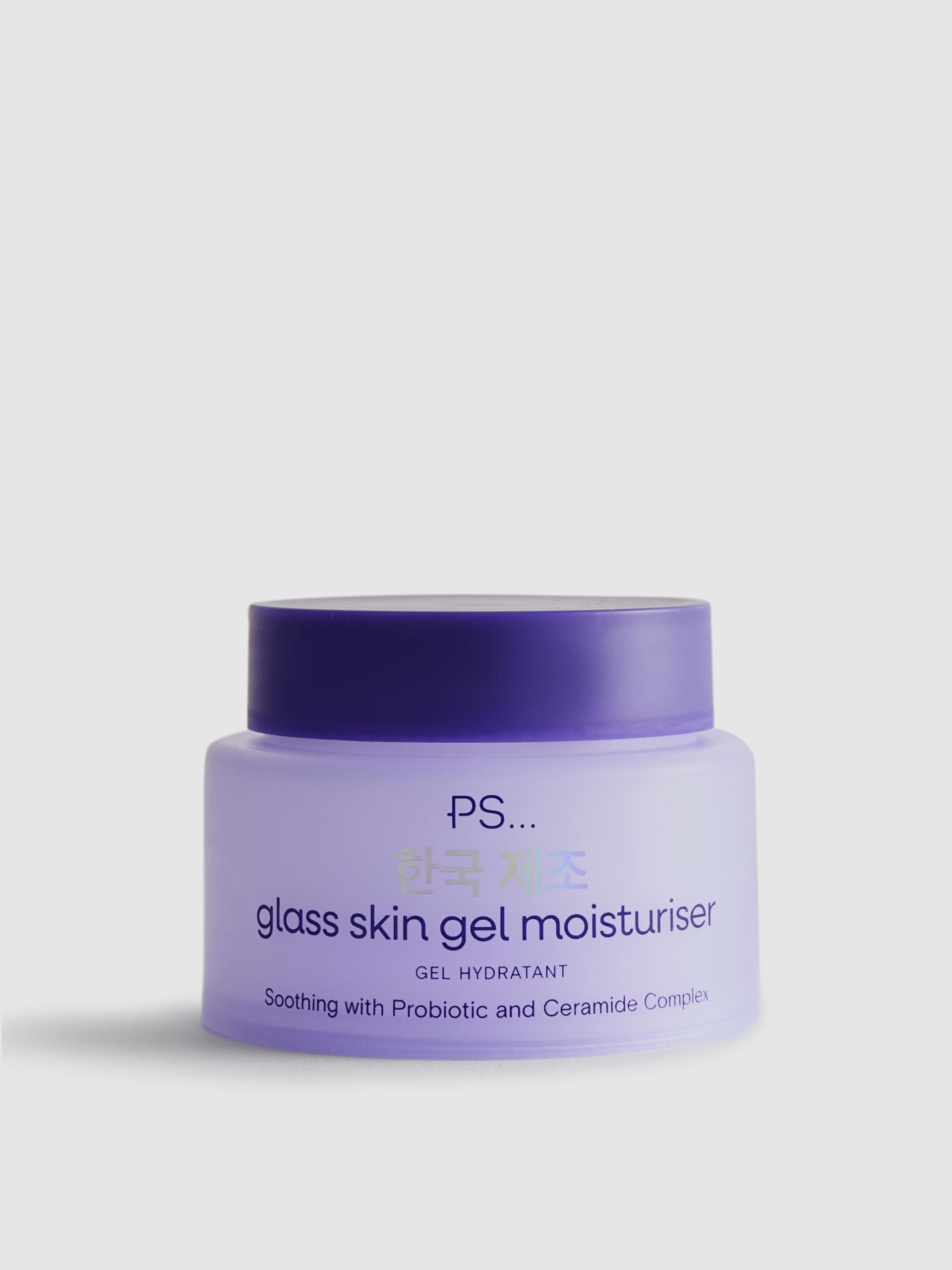 A short and wide cylindrical frosted purple plastic tub with a dark purple plastic lid that has Primark PS… Glass Skin Gel Face Moisturiser written in dark purple writing on it, on a white background.