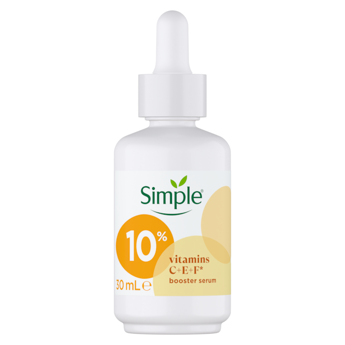 Brighter Skin Is As Simple As c, E, F | Simple Glow+ 10% Vitamin C + E + F Serum A short cylindrical bright white glass bottle with a bright white rubber pipette lid and a bright white label that has Simple written in bright green writing, Glow+ 10% Vitamin C + E + F Serum written in dark brown writing, and a picture of two dark green leaves on it, on a white background.