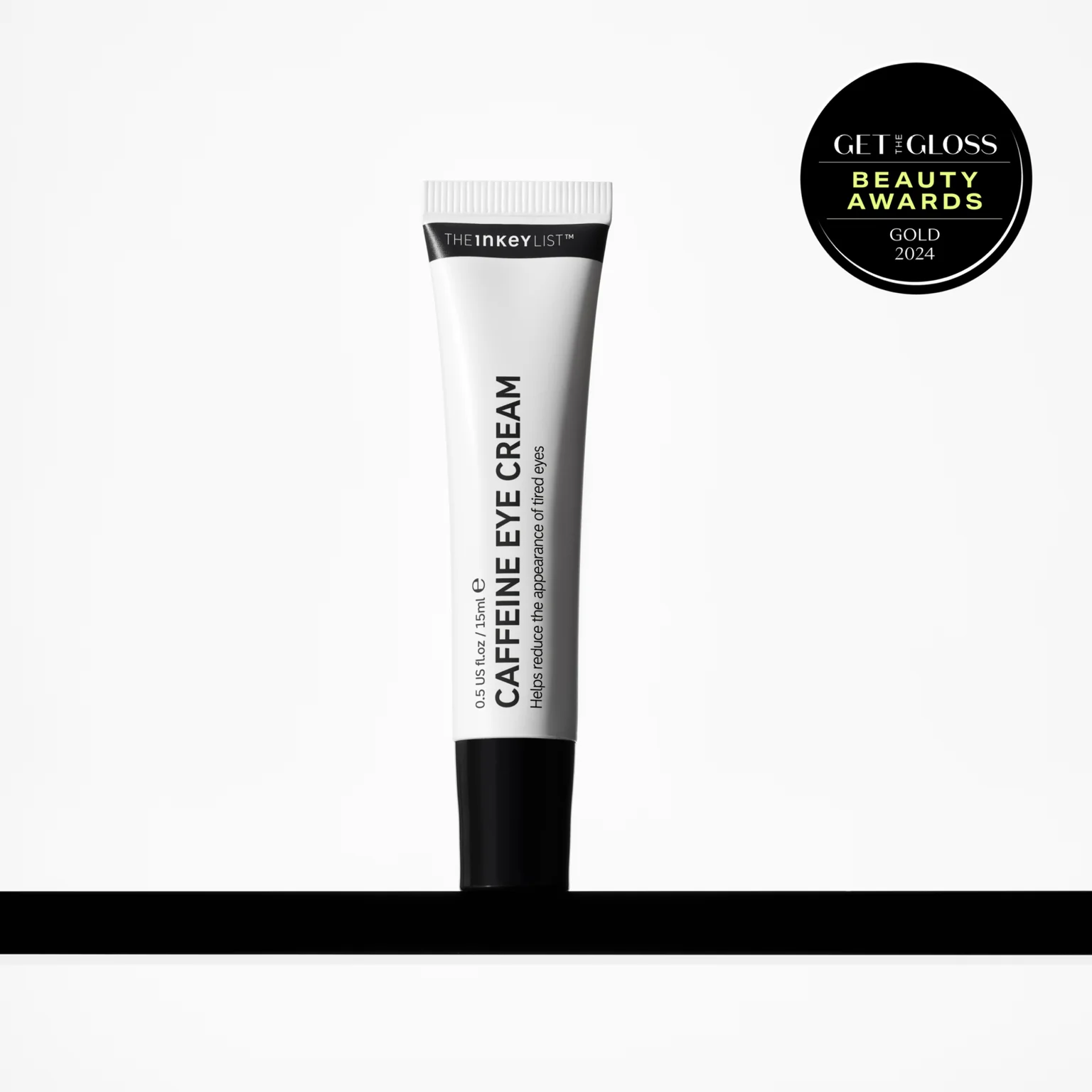 Tattooing Moisture Into My Under-Eyes | The INKEY List Caffeine Eye Cream A tall thin and conical bright white plastic tube with a black plastic lid that has The INKEY List Caffeine Eye Cream written in bold black writing and a picture of a black stripe on it, on a white background.