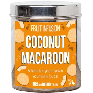 A tall cylindrical bright silver metal tin with a bright silver metal lid and a bright orange label that has Coconut Macaroon loose Leaf Tea written in bright white writing and some pictures of some golden brown coconut macaroon biscuits and some pieces of coconut on it, on a white background.