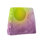 Fly Me To The Moon, Let Me Play Among The Stars | Lush Father's Day 2026 Range A medium gradient bright green and Lavender Purple trapezium shaped block of soap that has a bright Lime green semi-circle Moon and a gradient light and dark purple marbled swirling pattern engraved on it, on a white background.