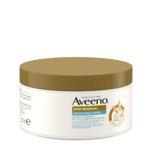 A short and wide cylindrical bright white plastic tub with a light brown plastic lid and a bright white label that has Aveeno Skin Renewal Smoothing Cream written in bold black writing and a picture of some oats on a stork on it, on a white background.