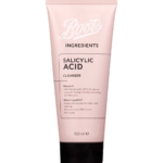 A tall and wide conical light pink plastic tube with a black plastic lid that has Boots written in bright white writing and Ingredients Salicylic Acid Cleanser written in bold black writing on it, on a white background.