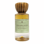 Even Your Dad Loves A Nice Walk In The Woods | The Yorkshire Soap Company Father's Day 2026 Range A tall cylindrical clear glass bottle full of some golden amber liquid with a circular dark wooden lid and a pale green label that has The Yorkshire Soap Company Yorkshire Woods Eau De Parfum written in bold black writing and a picture of a black crown on it, on a white background.