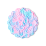Fairytales Are Real | Lush Unicorn Horn Bubble Bar and Prince Charming Shower Cream A medium marbled bright blue and pink mooncake shaped bubble bar that has some scolloped edges all over it, on a black background.