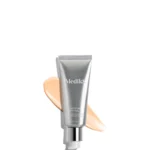 Crystals Aren't The Only Thing That Have A Smooth & Youthful Appearance | Medik8 Crystal Retinal 6 A tall conical metallic silver plastic tube with a metallic silver pump lid that has Medik8 Crystal Retinal written in bright white writing on it surrounded by some large streaks of some creamy beige Facial Serum, on a white background.