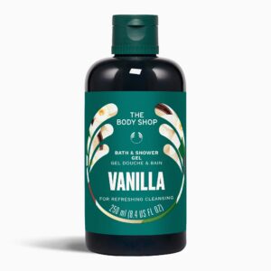A tall cylindrical dark green plastic Bottle with a dark green plastic lid and a bright Green label that has The Body Shop Vanilla Bath & Shower Cream written in bright white writing, some pictures of some small creamy white Vanilla Flowers, and some pictures of some dark brown Vanilla Pods on it, on a white background.