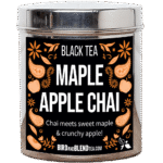 Tea Tastes Terrific | Bird & Blend Tea Company Autumn 2026 Collection A tall cylindrical bright silver metal tin with a bright silver metal lid and a black label that has Maple Apple Chai loose Leaf Tea, Black Tea, Chai meets sweet Maple and crunchy Apple written in bright white writing and some pictures of some bright orange apples, some flowers, some paisley shapes and some small bright orange leaves on it, on a white background.