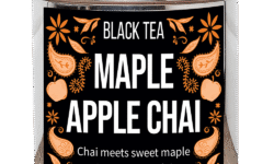 A tall cylindrical bright silver metal tin with a bright silver metal lid and a black label that has Maple Apple Chai loose Leaf Tea, Black Tea, Chai meets sweet Maple and crunchy Apple written in bright white writing and some pictures of some bright orange apples, some flowers, some paisley shapes and some small bright orange leaves on it, on a white background.