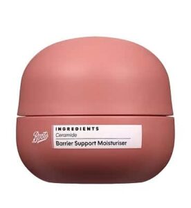 A short rounded cylindrical bright pink matte plastic tub with a rounded dome bright pink plastic lid and a bright white label that has Boots Ingredients Barrier Support Ceramide Moisturiser written in bold black writing on it, on a white background.