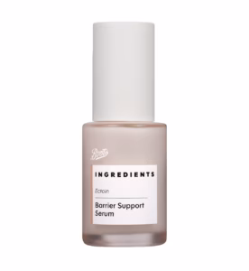 A short cylindrical frosted glass bottle with a matte cream plastic lid and a bright white label that has Boots Ingredients Barrier Support Ectoin Serum written in bold black writing on it, on a white background.